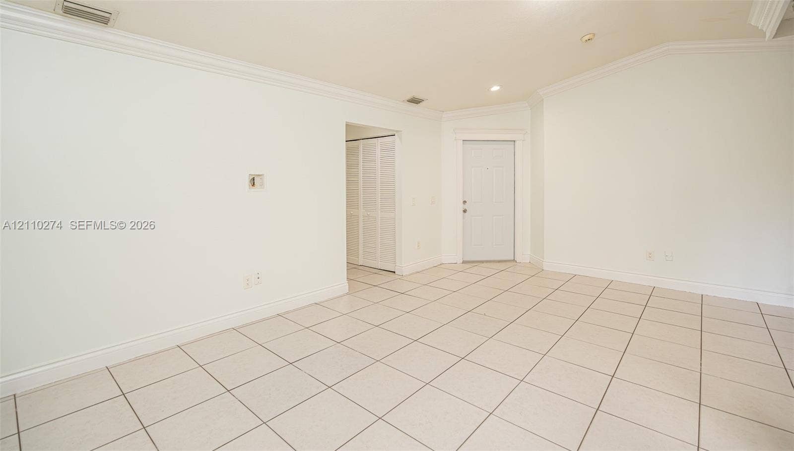 14955 SW 49th Lane, #5E, Miami, FL 33185 Vaulted ceilings, large-format tile flooring, crown molding, and louvered bifold closet doors