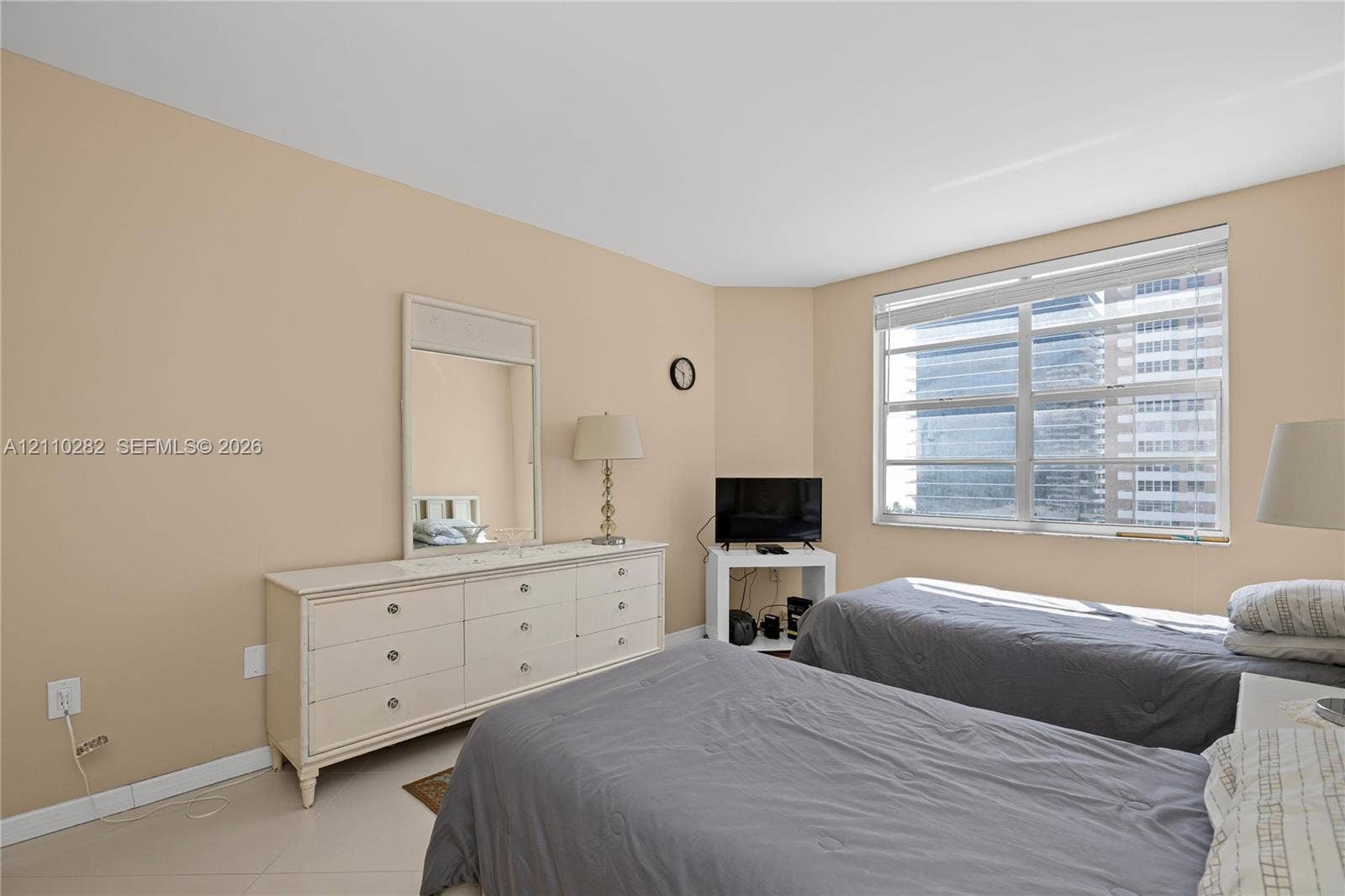 Neutral wall tones, large window with multi-pane glazing, and tile flooring