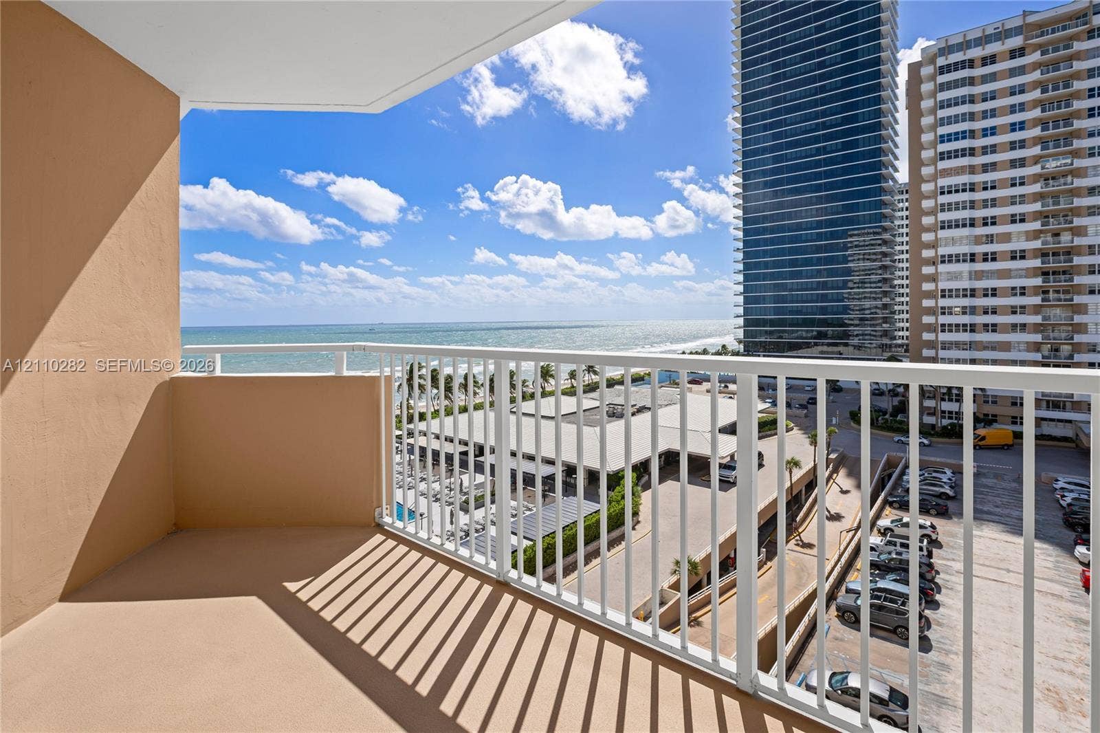 Private balcony featuring a white metal railing and solid concrete flooring