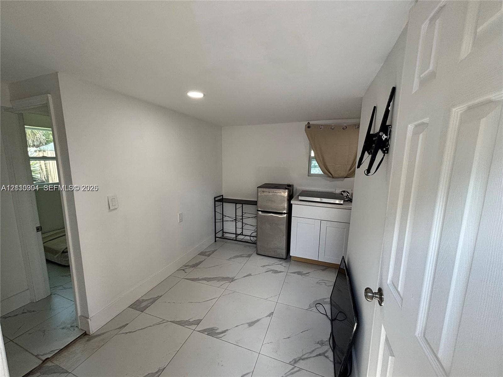 729 NW 19th Avenue, Fort Lauderdale, FL 33311 Large-format tile flooring, white shaker-style cabinetry, and recessed lighting