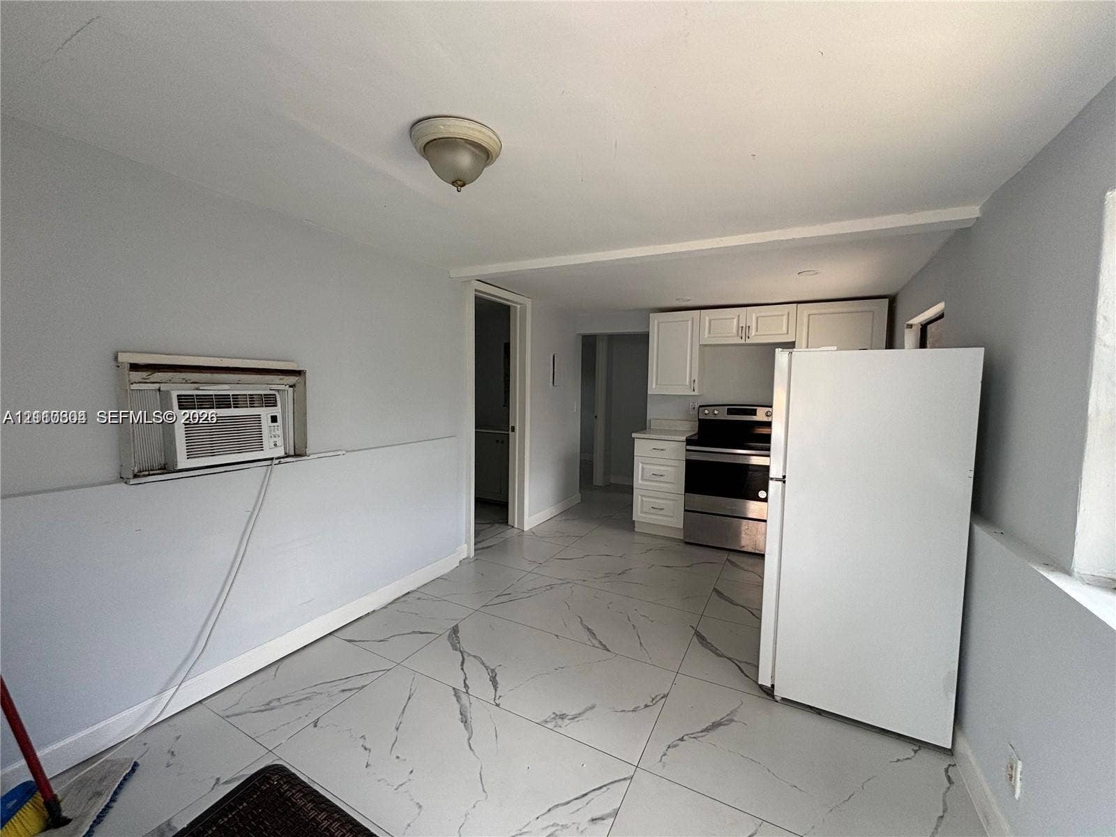 729 NW 19th Avenue, Fort Lauderdale, FL 33311 Large-format tile flooring, white cabinetry, and stainless-steel appliances