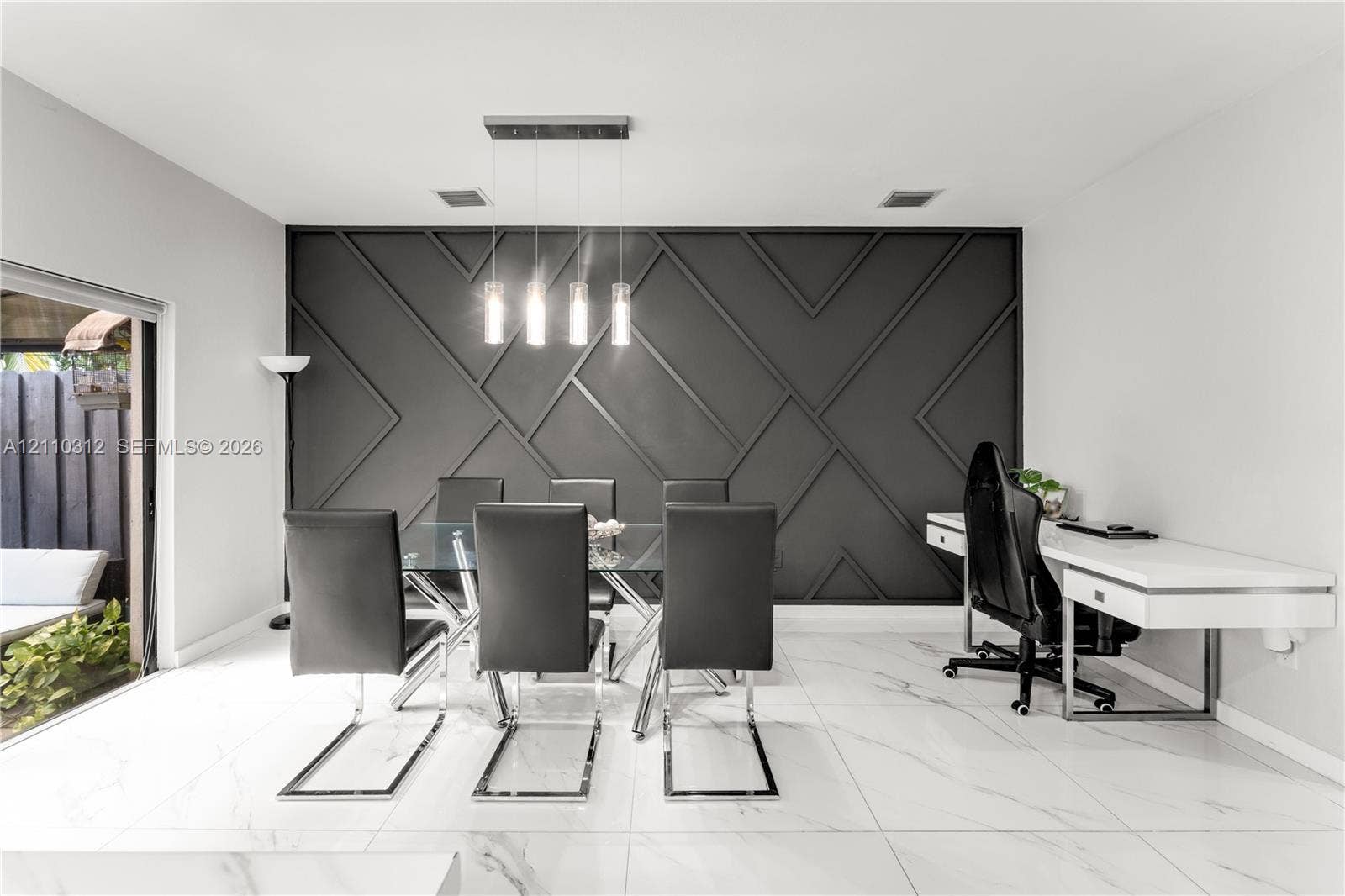11524 SW 248th Lane, Homestead, FL 33032 Geometric accent wall with matte black finish, large-format tile flooring, and four-light linear pendant fixture