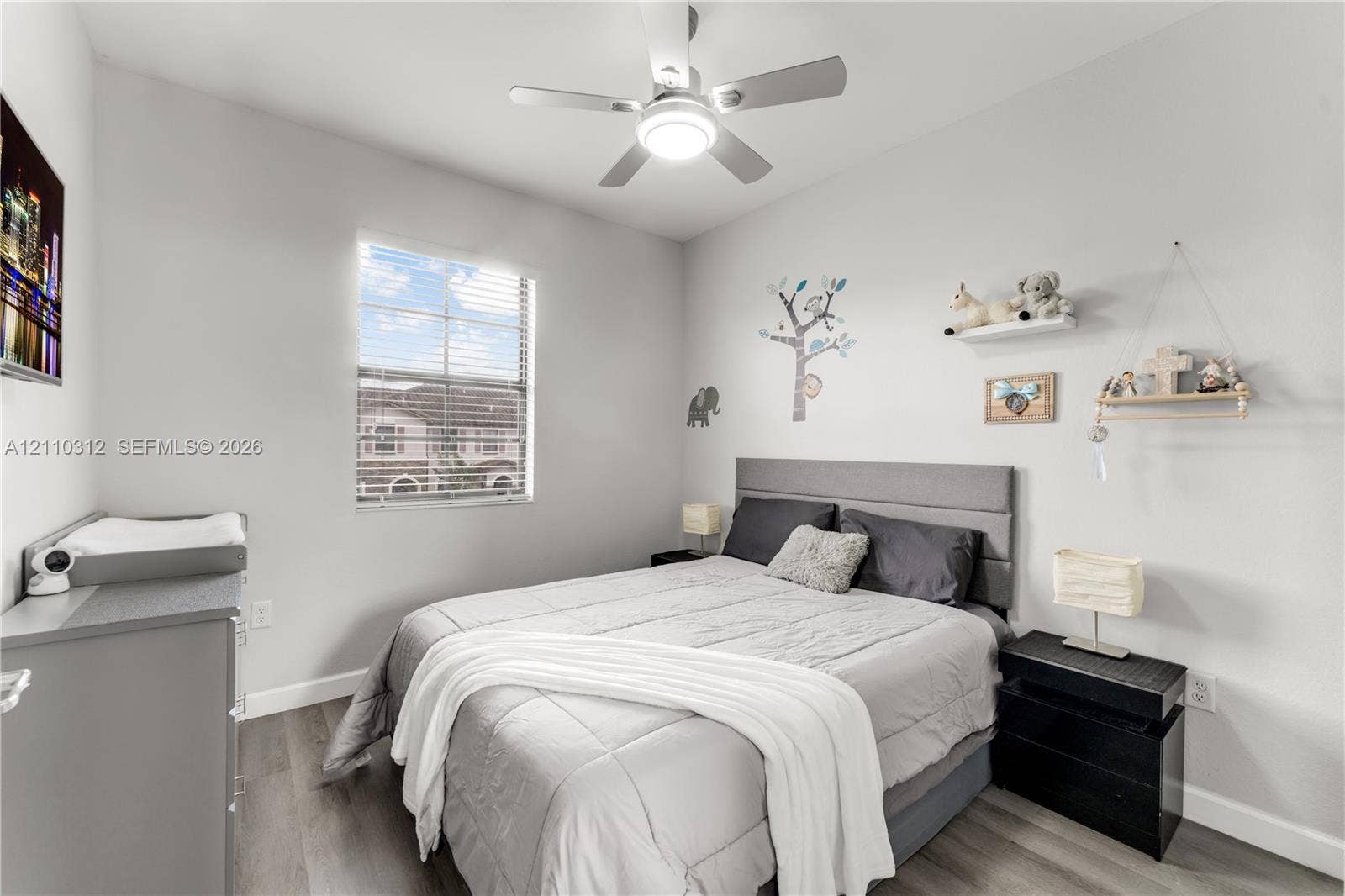 11524 SW 248th Lane, Homestead, FL 33032 Bedroom featuring wood-finish flooring, a neutral color palette, a single-pane window with horizontal blinds, and a ceiling-mounted light fixture with an integrated fan