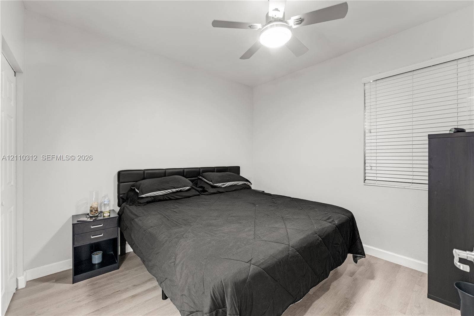 11524 SW 248th Lane, Homestead, FL 33032 Interior room featuring wood-finish flooring, white walls, horizontal window blinds, and a ceiling fan with integrated light fixture