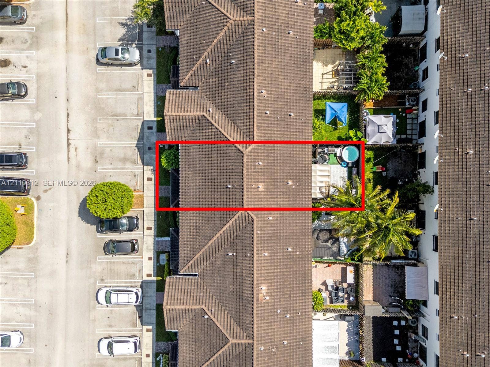 11524 SW 248th Lane, Homestead, FL 33032 Aerial perspective featuring a tile roof, private enclosed outdoor area, and paved surface