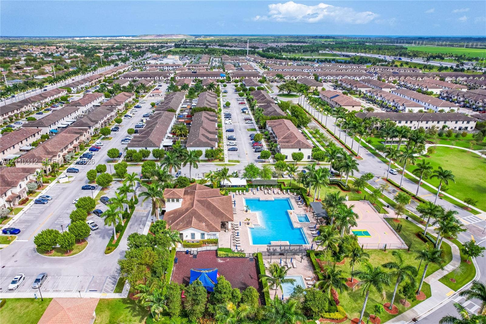11524 SW 248th Lane, Homestead, FL 33032 Aerial view of community amenity center featuring a swimming pool, spa, sport court, playground, and clubhouse