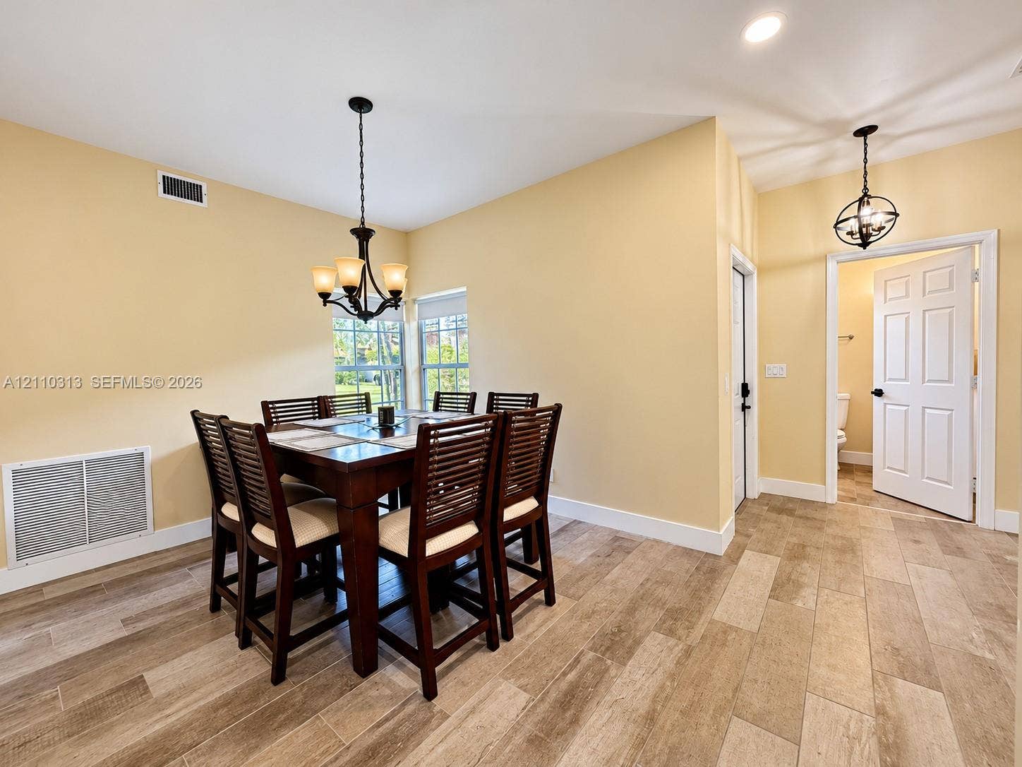 17731 SW 23rd Street, Miramar, FL 33029 Wood-finish tile flooring, recessed lighting, and dual tiered chandeliers featuring multi-light fixtures