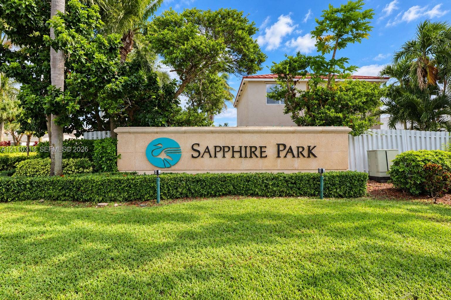17731 SW 23rd Street, Miramar, FL 33029 Community entrance monument featuring a stone-clad wall, dimensional lettering, professional landscaping, and manicured turf