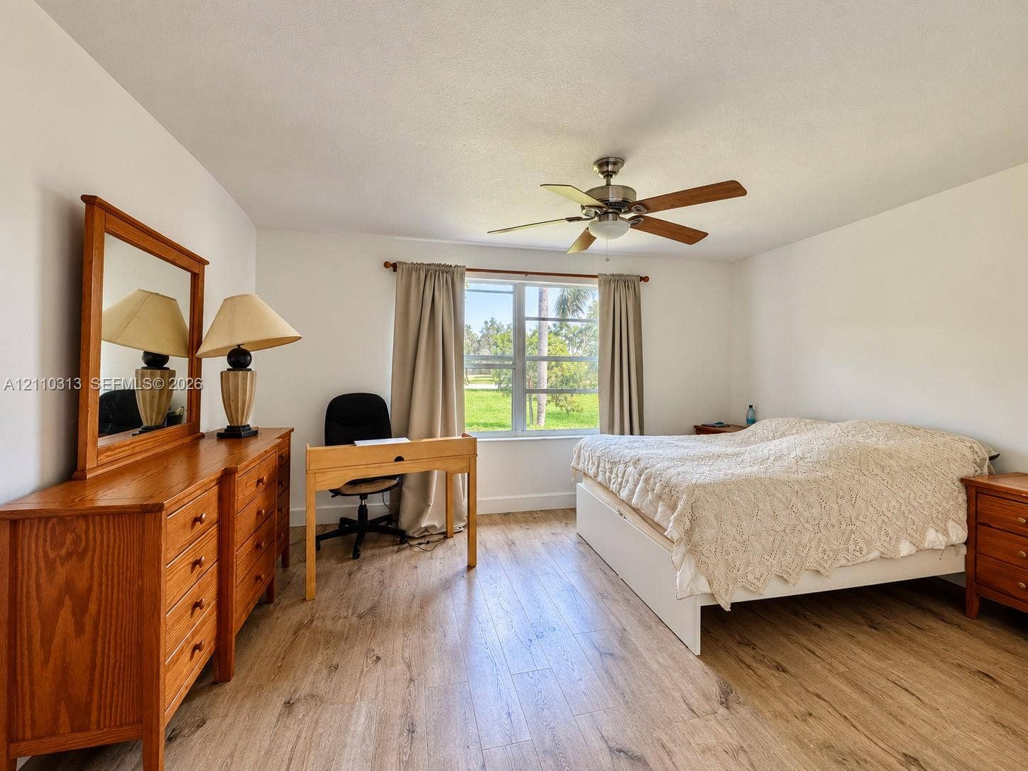 17731 SW 23rd Street, Miramar, FL 33029 Wood-finish flooring, multi-pane window, and integrated ceiling fan with light fixture
