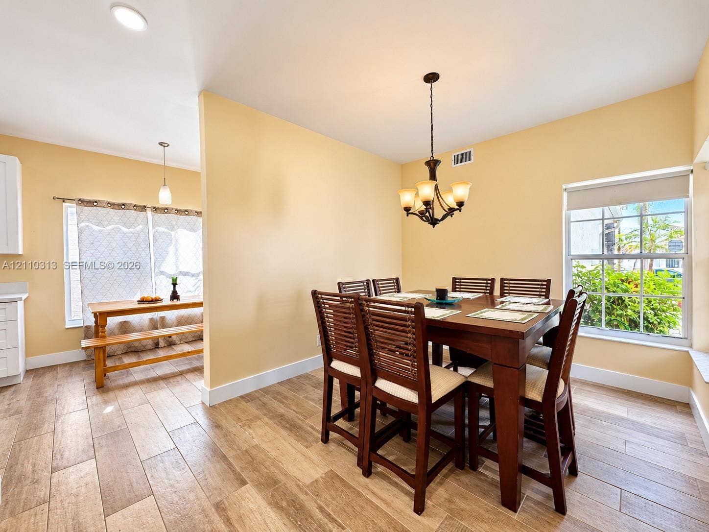 17731 SW 23rd Street, Miramar, FL 33029 Wood-finish tile flooring, multi-light chandelier, recessed lighting, and large windows providing natural illumination