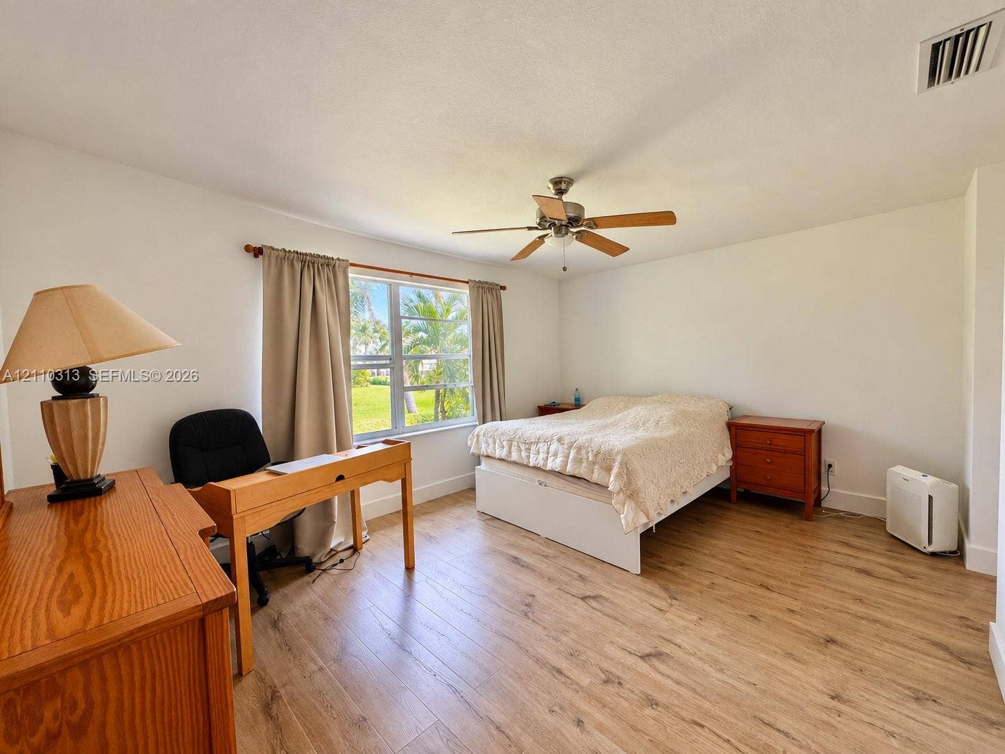 17731 SW 23rd Street, Miramar, FL 33029 Bedroom featuring wood-finish flooring, a multi-blade ceiling fan, and a single-pane window