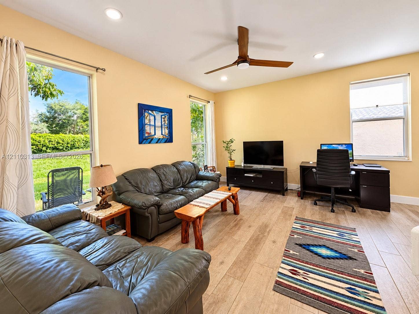 17731 SW 23rd Street, Miramar, FL 33029 Wood-finish tile flooring, recessed ceiling lighting, three large picture windows, and a ceiling fan