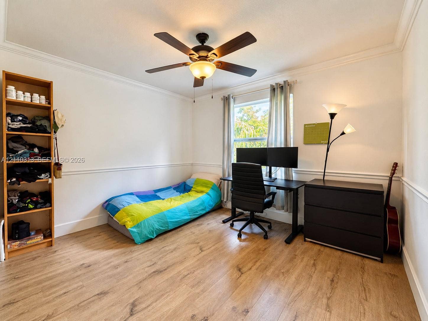17731 SW 23rd Street, Miramar, FL 33029 Room featuring wood-finish flooring, chair rail molding, crown molding, and a central ceiling fan with an integrated light fixture