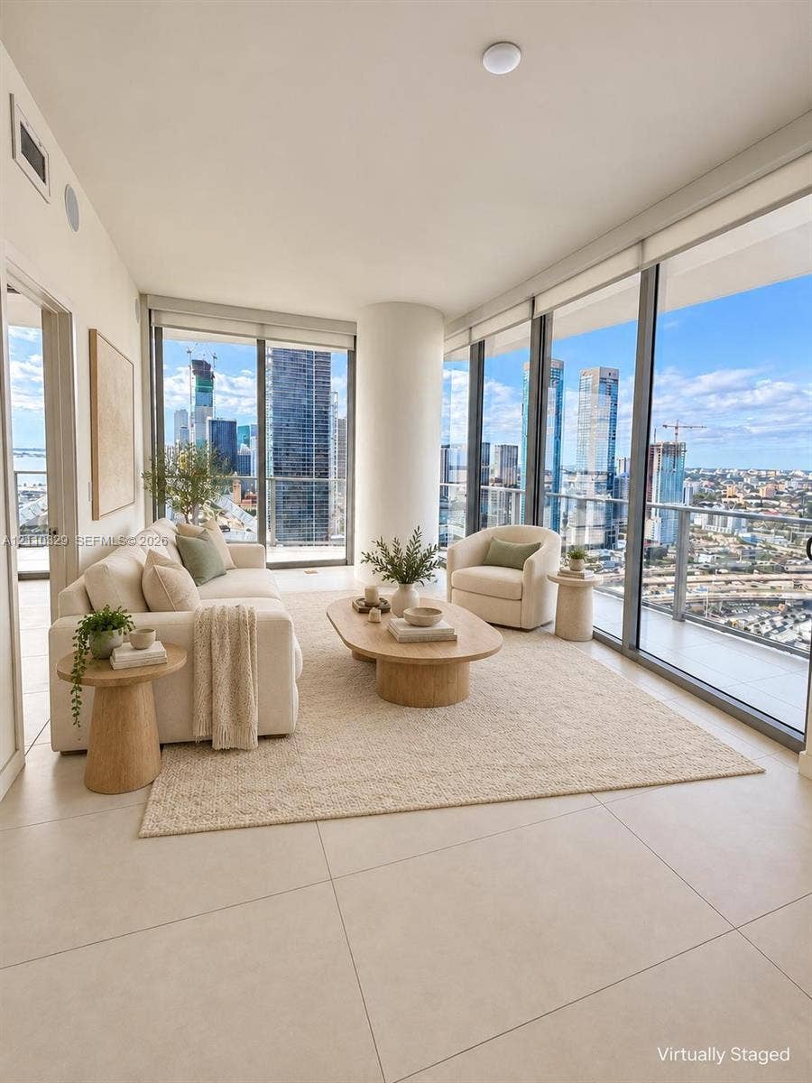 Floor-to-ceiling windows, porcelain tile flooring, structural column, and an expansive balcony