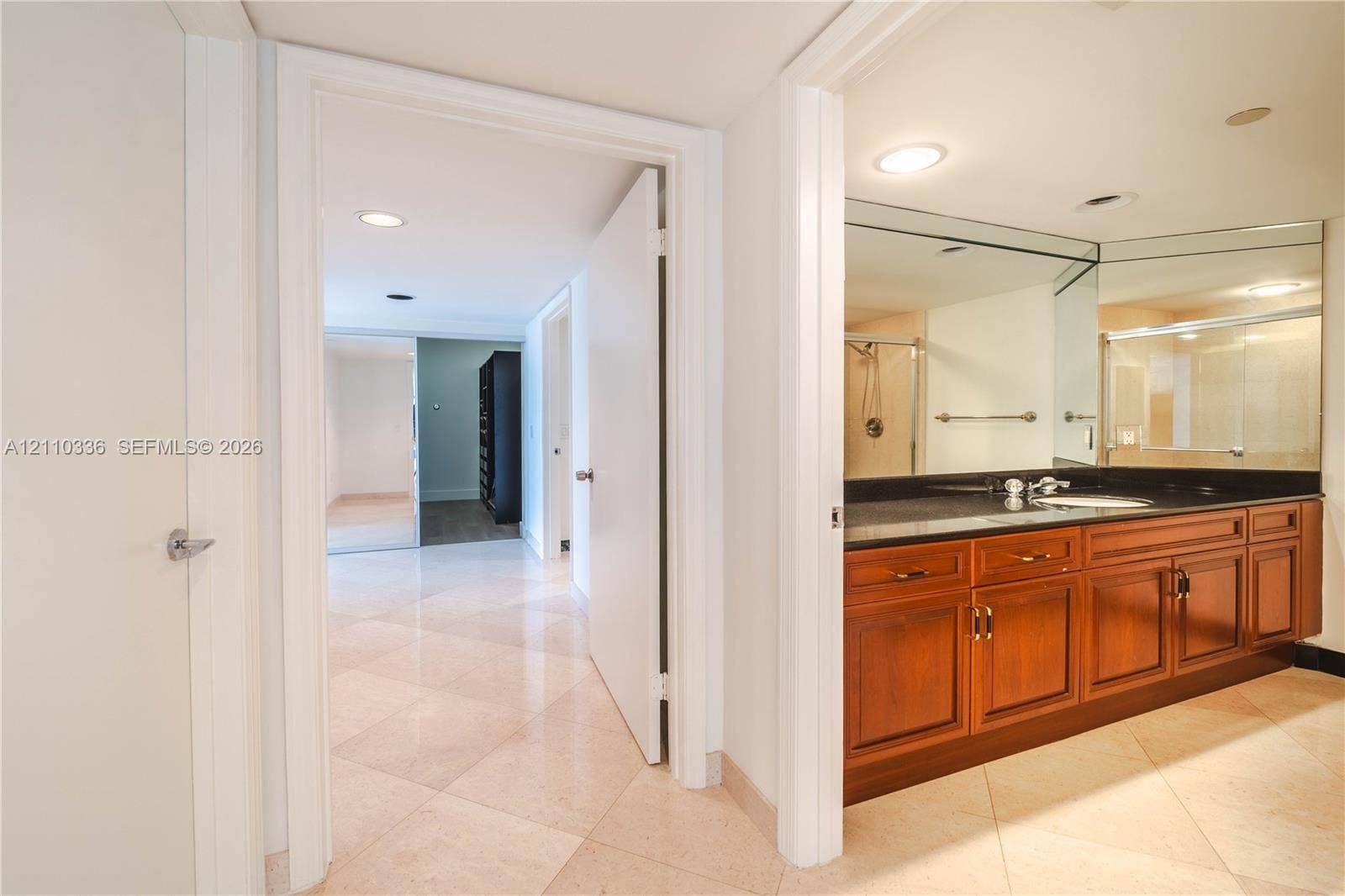 16445 Collins Avenue, #WS-7B, Sunny Isles Beach, Sunny Isles Beach, FL 33160 Bathroom featuring a wood-tone vanity, dark solid-surface countertop, full-width mirror, recessed lighting, and stone-finish flooring