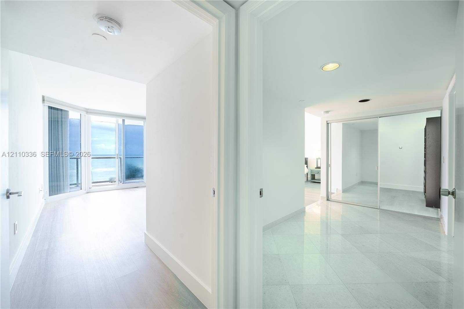 16445 Collins Avenue, #WS-7B, Sunny Isles Beach, Sunny Isles Beach, FL 33160 Floor-to-ceiling glass sliding doors, private balcony, large-format tile flooring, and mirrored sliding closet doors