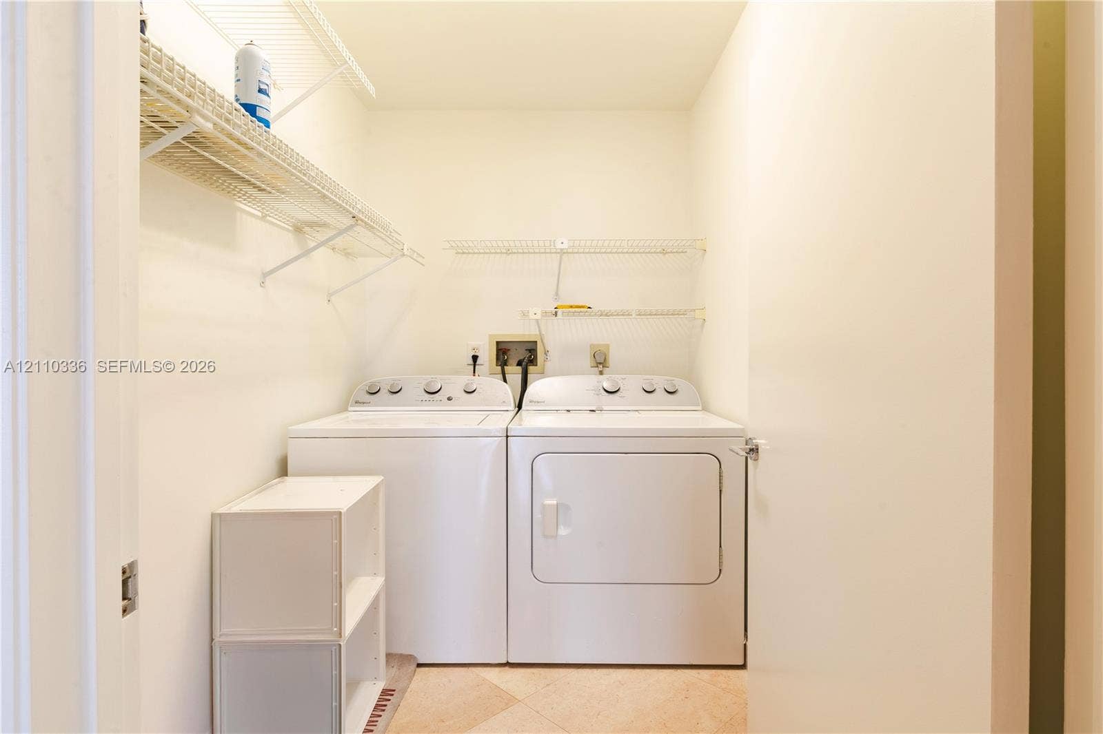 16445 Collins Avenue, #WS-7B, Sunny Isles Beach, Sunny Isles Beach, FL 33160 Utility area featuring white metal wire shelving and neutral-toned tile flooring