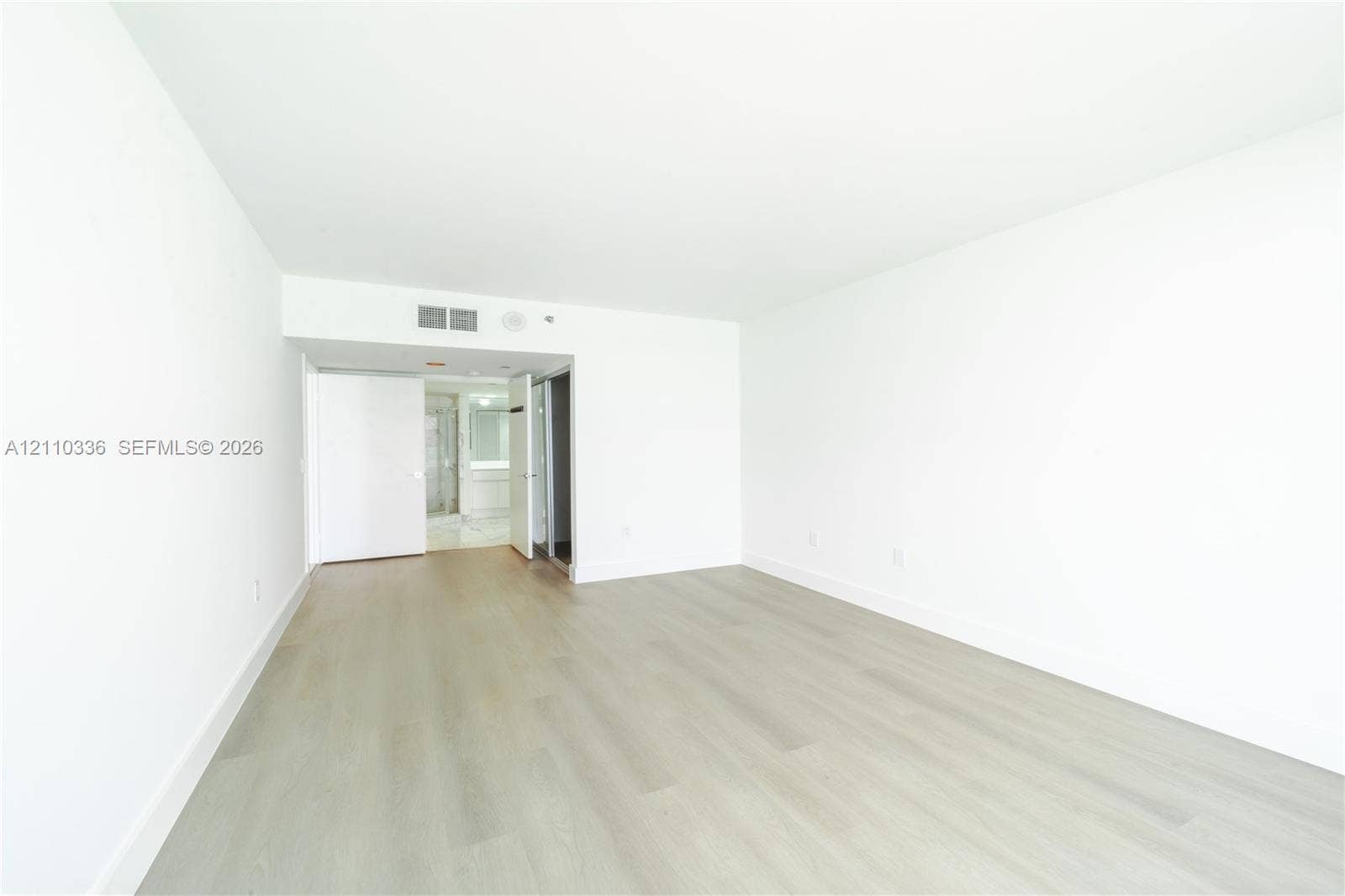 16445 Collins Avenue, #WS-7B, Sunny Isles Beach, Sunny Isles Beach, FL 33160 Interior space featuring light-toned wood-finish flooring, smooth white walls, and solid-core interior doors