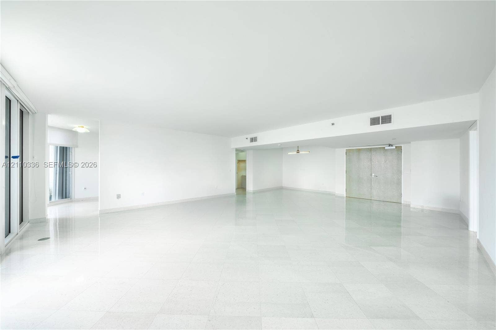 16445 Collins Avenue, #WS-7B, Sunny Isles Beach, Sunny Isles Beach, FL 33160 Open-concept interior featuring polished tile flooring, smooth ceilings, recessed lighting, and double-door closet entry