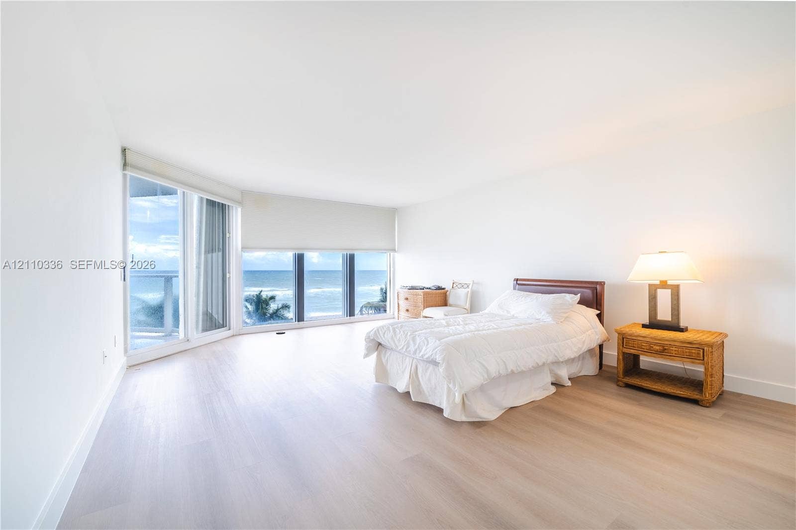 16445 Collins Avenue, #WS-7B, Sunny Isles Beach, Sunny Isles Beach, FL 33160 Expansive living area featuring floor-to-ceiling windows, light-toned wood-finish flooring, and an oceanic backdrop