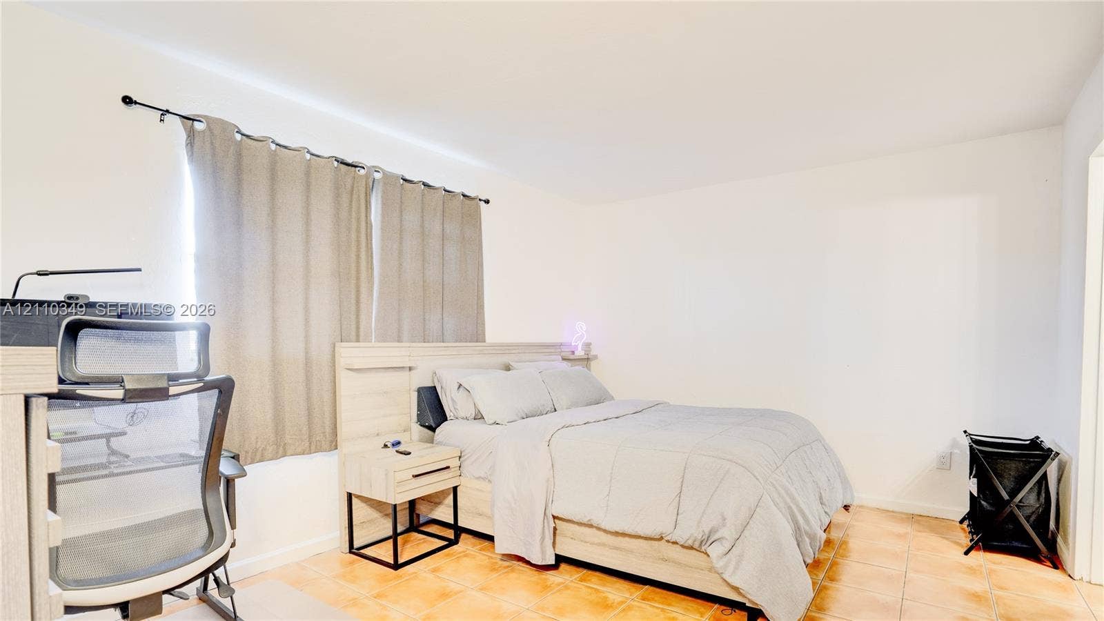 8600 SW 67th Avenue, #905, Pinecrest, Pinecrest, FL 33156 Neutral-toned interior space featuring light-colored tile flooring, smooth white walls, and a window with a mounted curtain rod