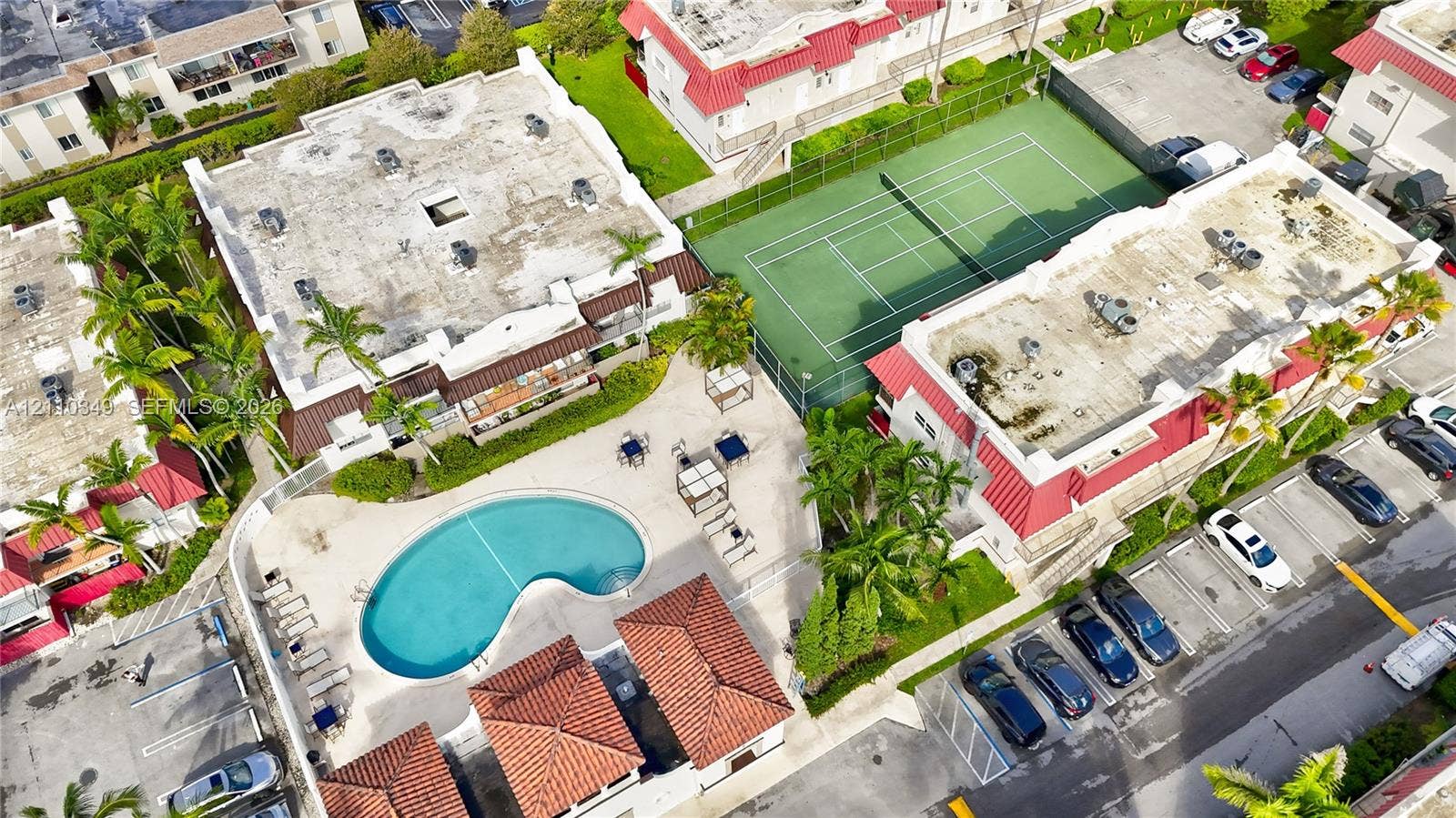 8600 SW 67th Avenue, #905, Pinecrest, Pinecrest, FL 33156 swimming pool, tennis court, and mature palm trees