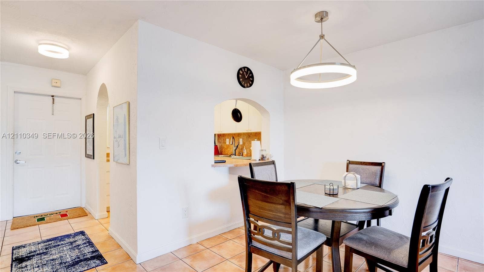 8600 SW 67th Avenue, #905, Pinecrest, Pinecrest, FL 33156 Ceramic tile flooring, arched wall pass-through, modern circular pendant lighting, and flush-mount ceiling lighting
