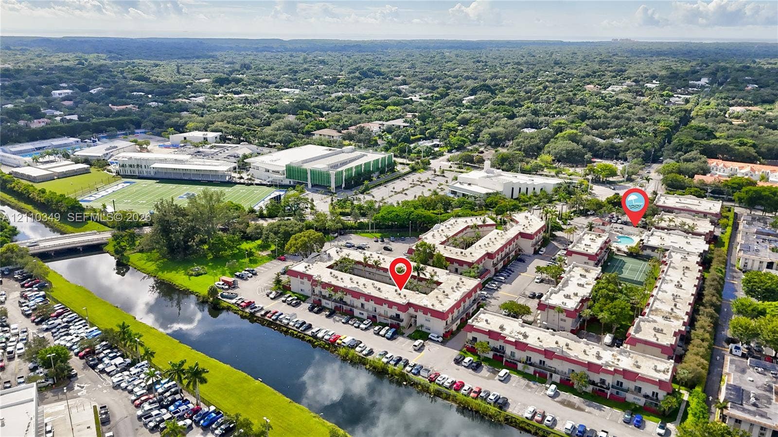 8600 SW 67th Avenue, #905, Pinecrest, Pinecrest, FL 33156 Aerial perspective of the complex featuring a multi-story building, an on-site swimming pool, and a tennis court