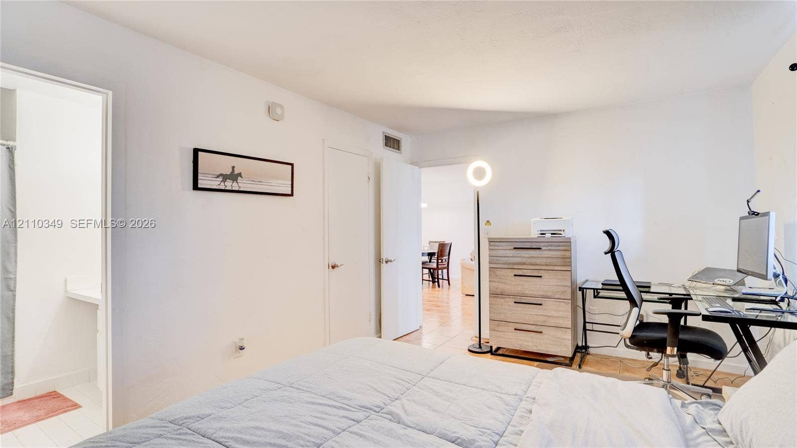8600 SW 67th Avenue, #905, Pinecrest, Pinecrest, FL 33156 Neutral interior featuring smooth white wall finishes, wood-finish flooring, and multiple doorways with metallic hardware