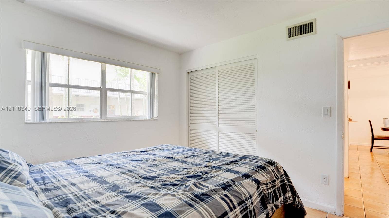 8600 SW 67th Avenue, #905, Pinecrest, Pinecrest, FL 33156 Bright room featuring large multi-pane windows and built-in closet storage with louvered doors