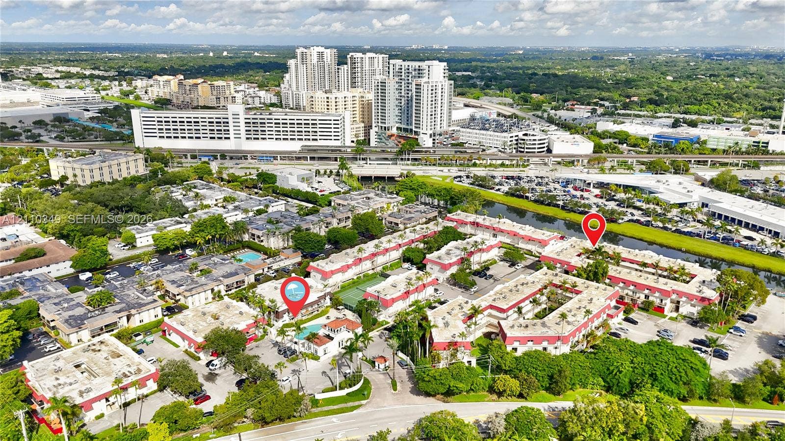 8600 SW 67th Avenue, #905, Pinecrest, Pinecrest, FL 33156 Aerial perspective of a multi-unit residential community featuring a centrally located swimming pool, tennis court, and dense perimeter landscaping
