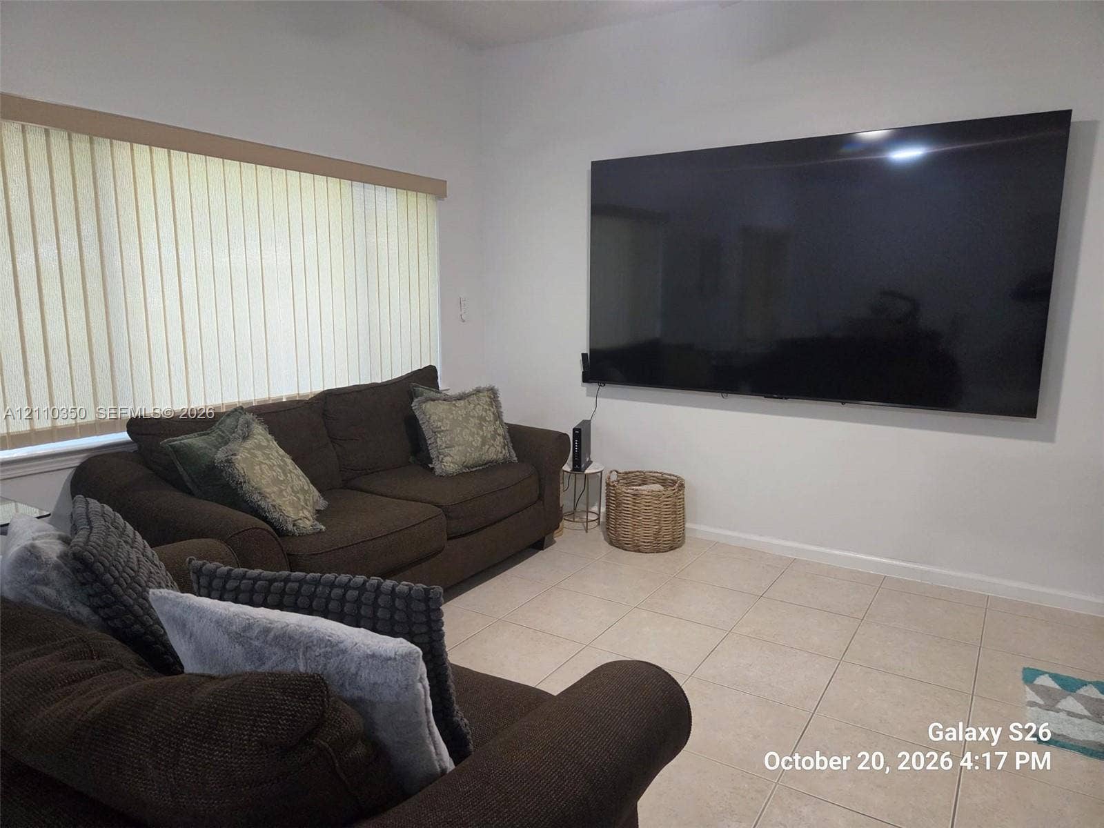 Neutral tile flooring and vertical window blinds