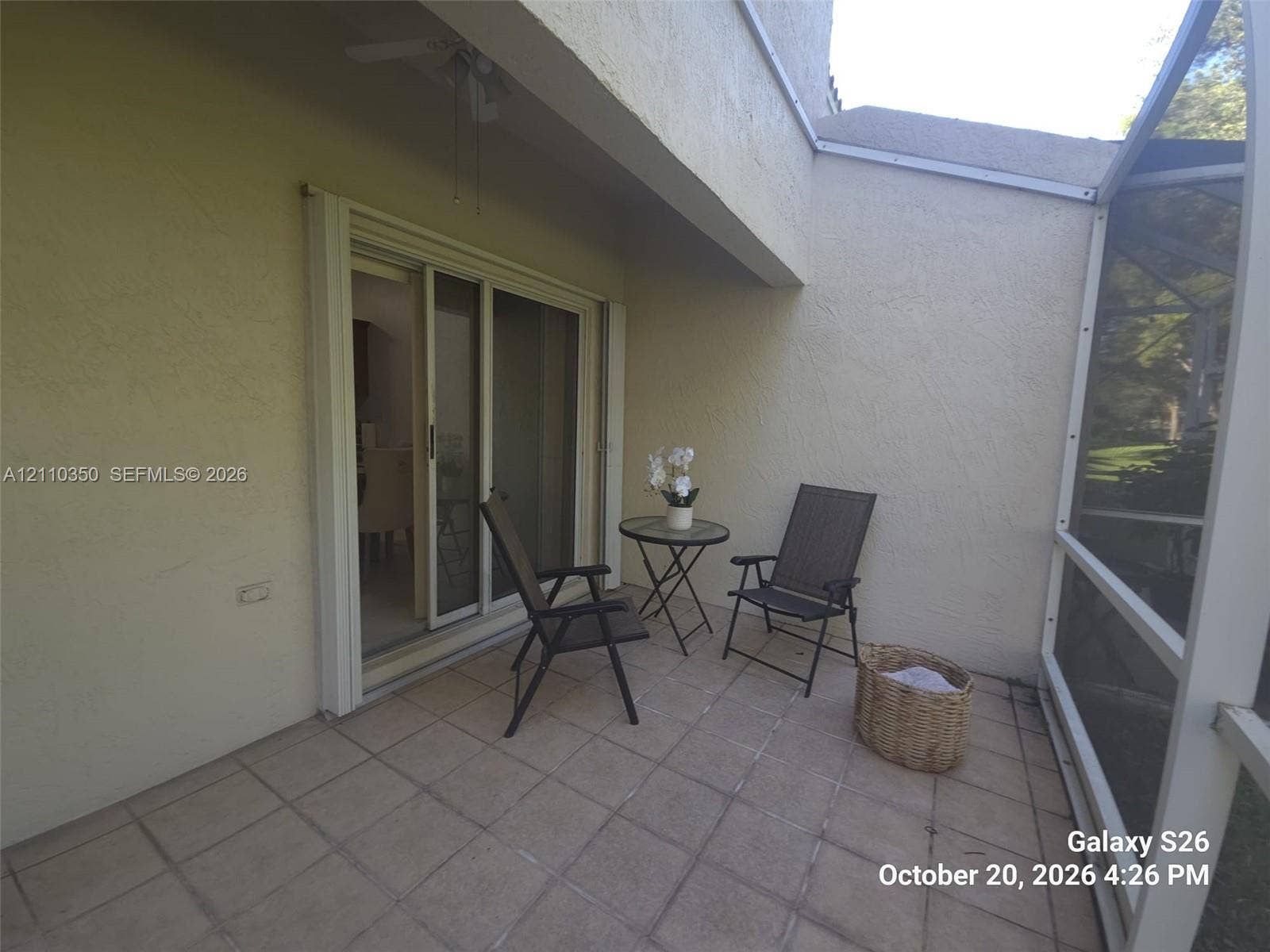 Screened-in patio featuring tile flooring and sliding glass door access