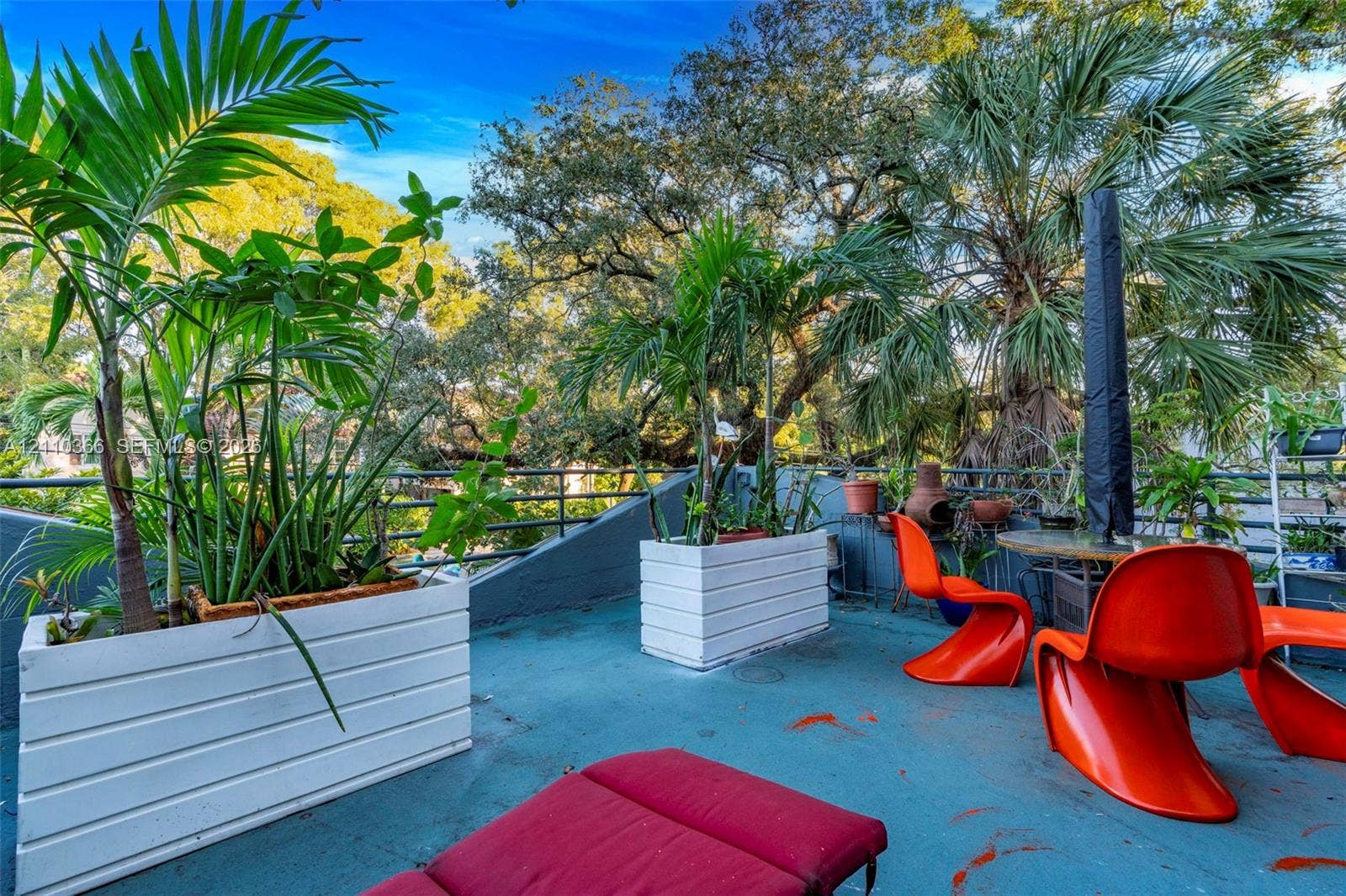 2361 SW 18th Avenue, Fort Lauderdale, FL 33315 Rooftop terrace featuring white horizontal-slat planters, mature trees, and metal railing