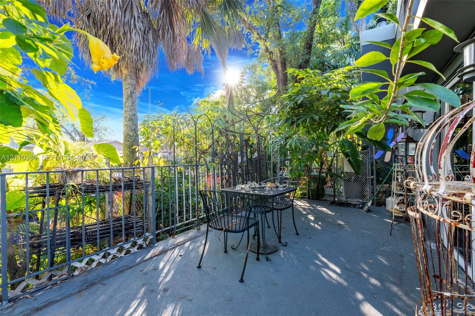 2361 SW 18th Avenue, Fort Lauderdale, FL 33315 Outdoor patio featuring a concrete floor, decorative metal perimeter fencing, and mature landscaping