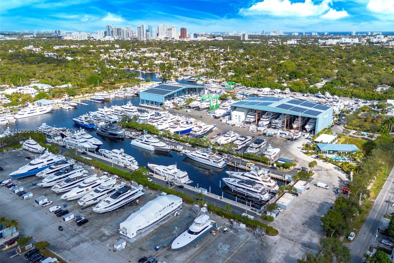 2361 SW 18th Avenue, Fort Lauderdale, FL 33315 Aerial perspective of a marina featuring extensive deep-water dockage, multiple climate-controlled boat storage hangars, paved hardstanding areas, and direct waterfront access