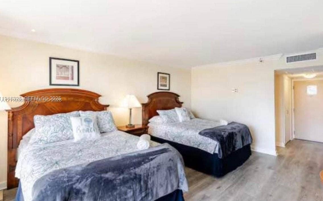 Neutral wall paint, wood-finish flooring, and recessed ceiling lighting