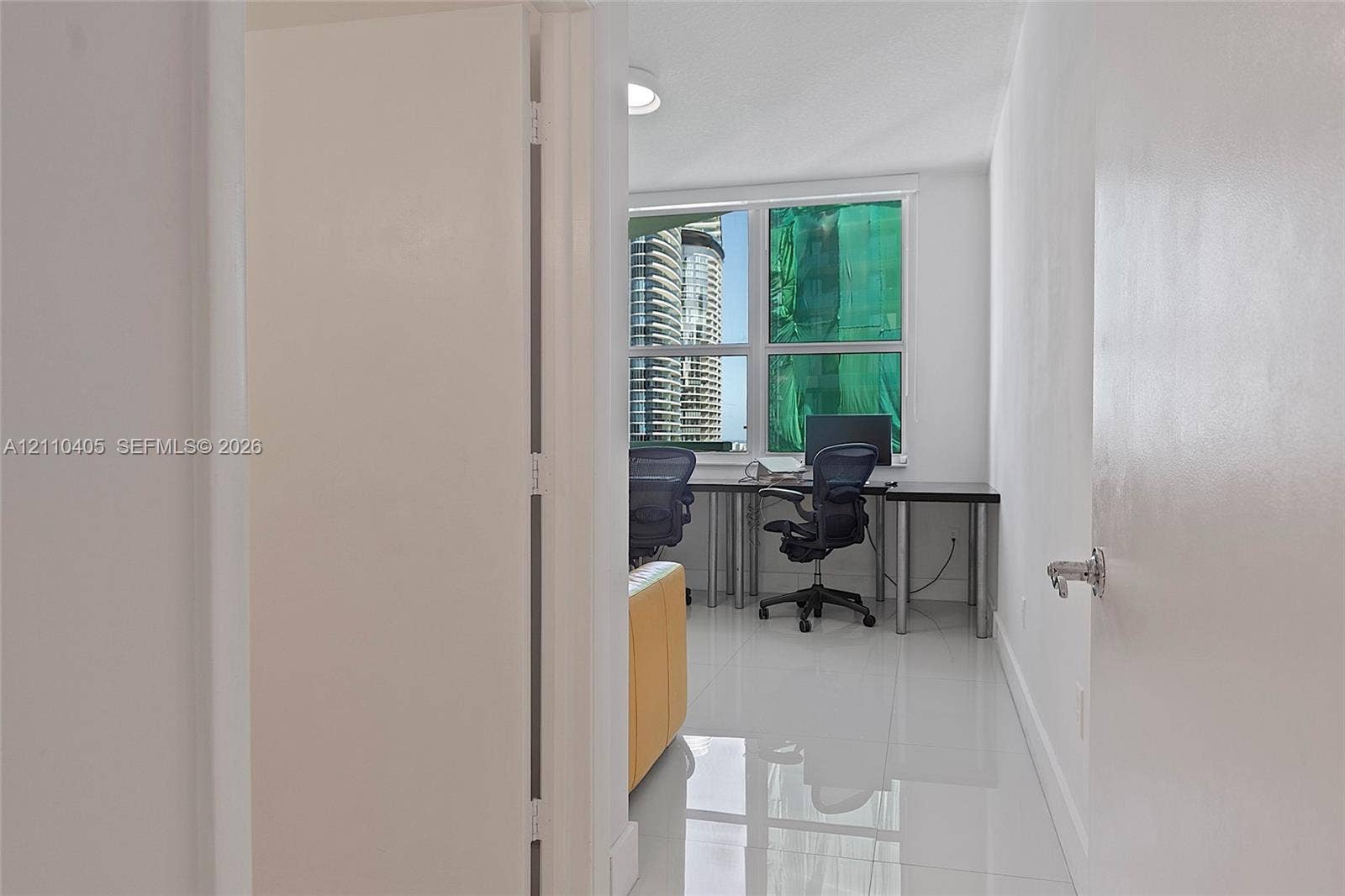 Polished tile flooring, large multi-pane windows, and a flush-mount ceiling light fixture