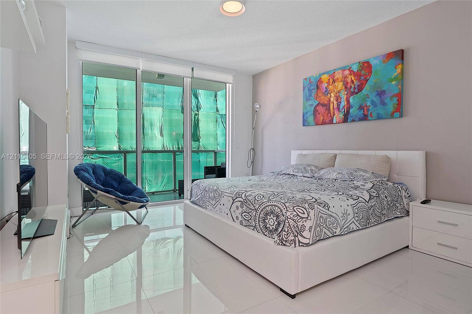 Floor-to-ceiling glass panel door, polished tile flooring, and recessed ceiling lighting