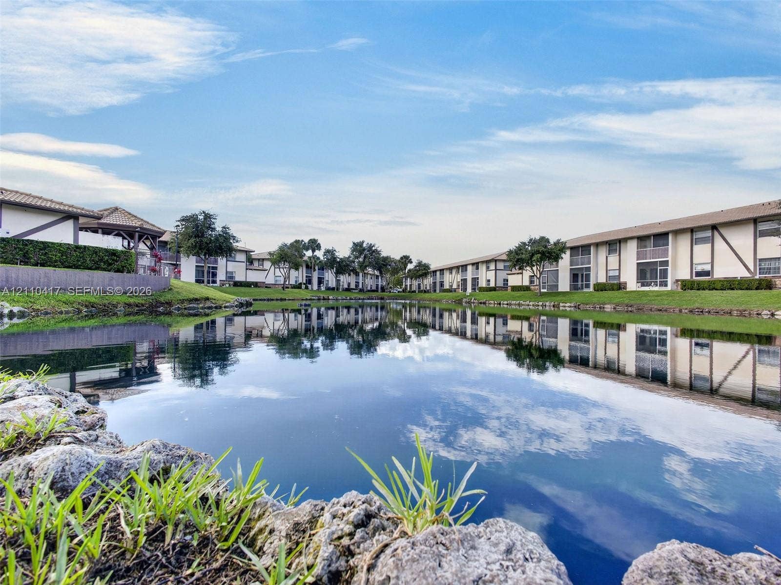 2369 NW 89th Drive, #514, Coral Springs, FL 33065 Serene waterfront setting with manicured grounds and mature landscaping