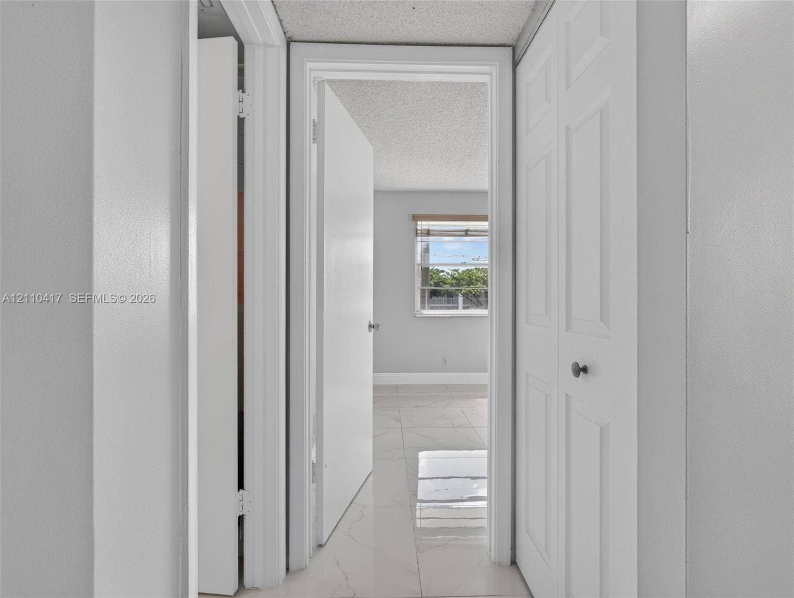 2369 NW 89th Drive, #514, Coral Springs, FL 33065 Light-colored tile flooring, white interior doors, and a double-panel closet door