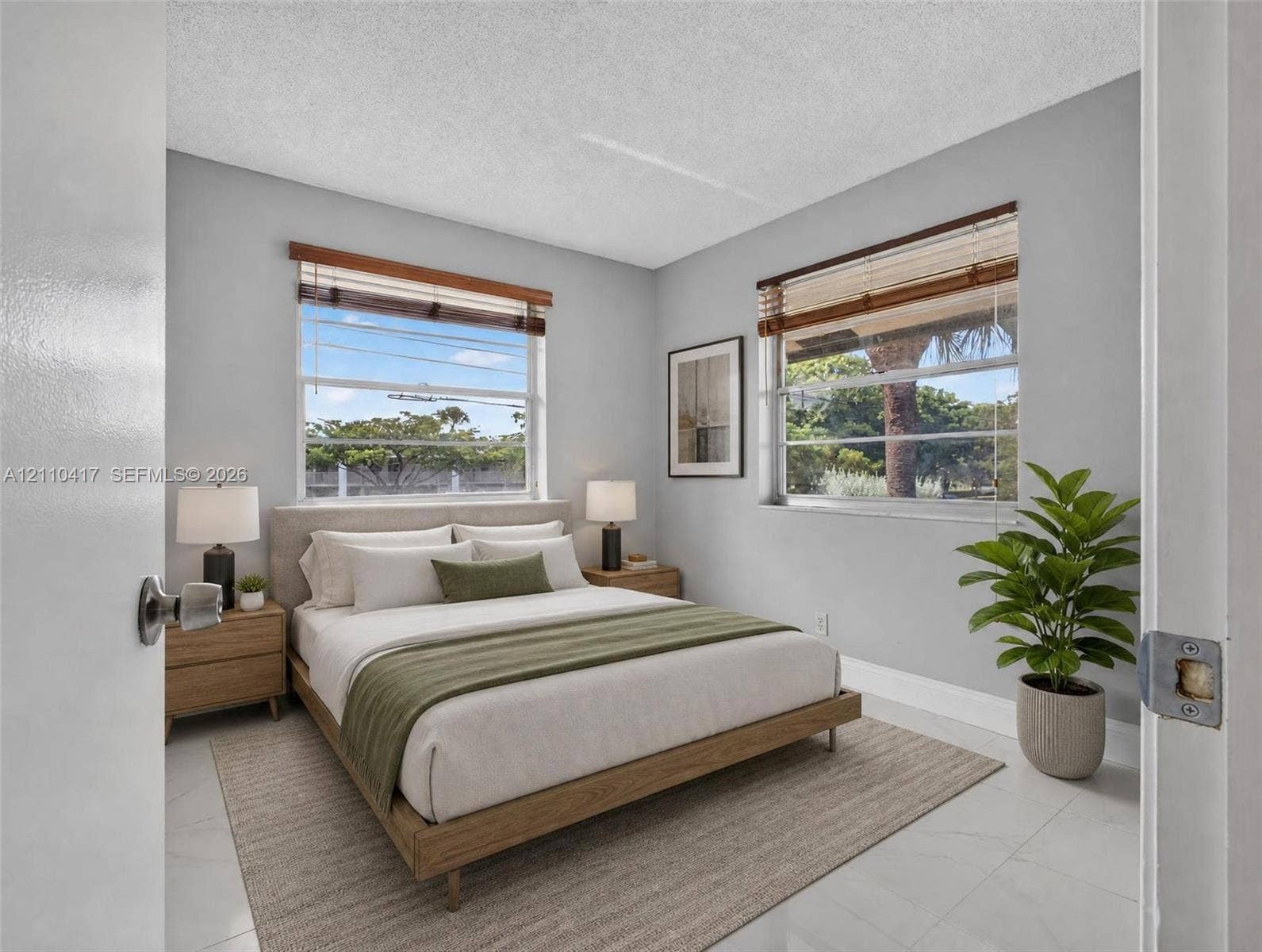 2369 NW 89th Drive, #514, Coral Springs, FL 33065 Bedroom featuring light-toned neutral walls, polished tile flooring, and dual windows with wooden blinds