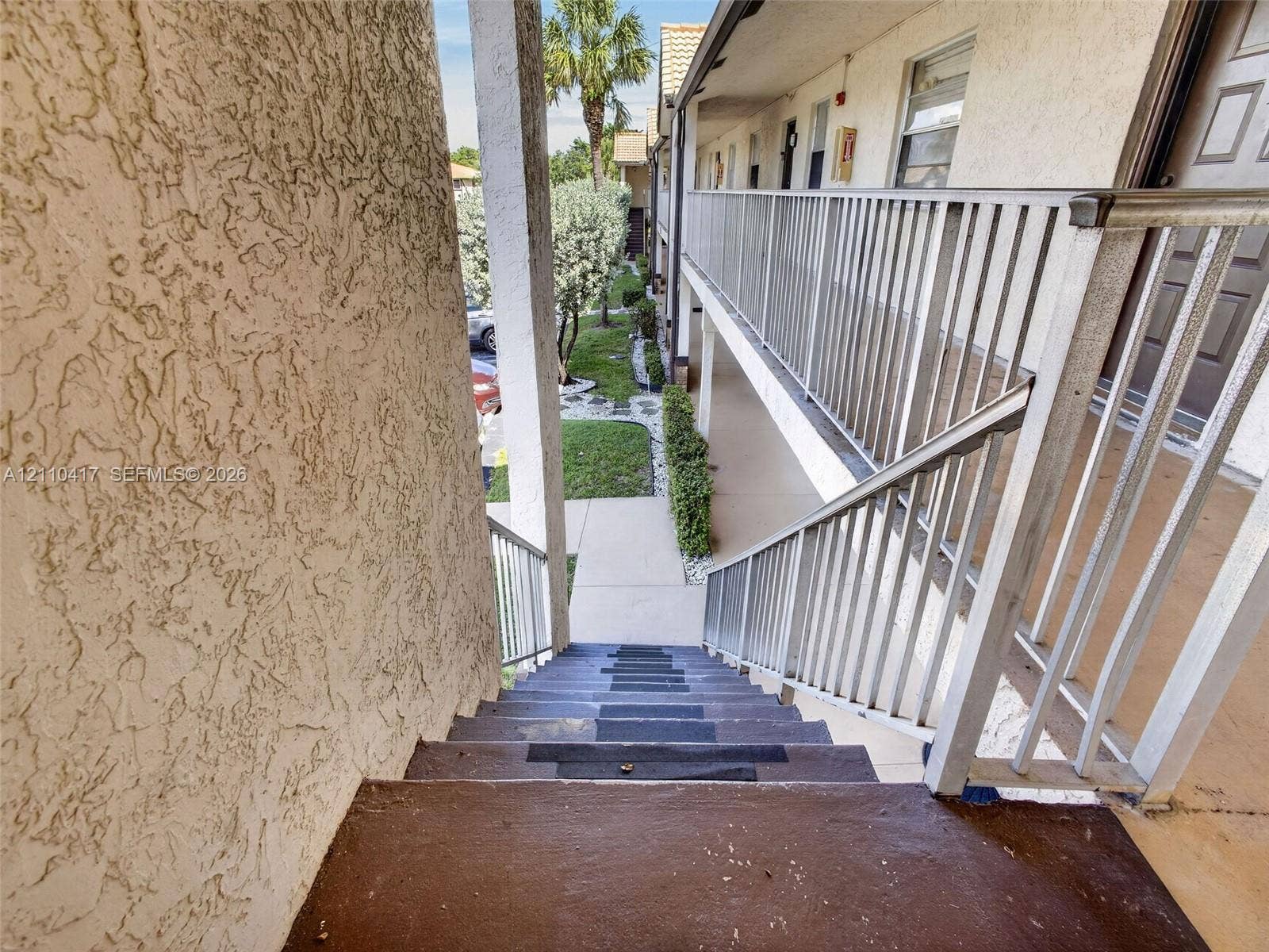 2369 NW 89th Drive, #514, Coral Springs, FL 33065 Stucco exterior staircase featuring metal railings and concrete walkway