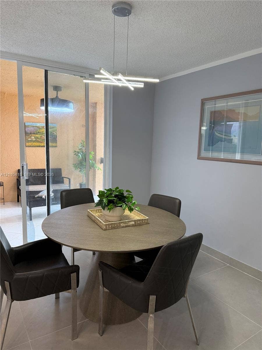 950 Egret Circle, #5409, Delray Beach, Delray Beach, FL 33444 Contemporary linear LED pendant lighting, neutral-toned tile flooring, and sliding glass patio door