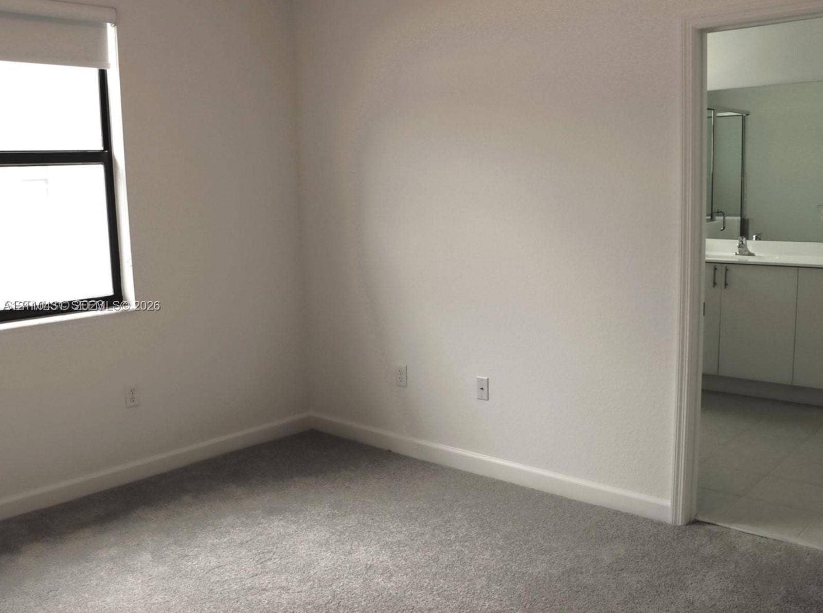 23452 SW 129th Avenue, Homestead, FL 33032 Neutral-toned interior room with wall-to-wall carpeting and a single-pane window