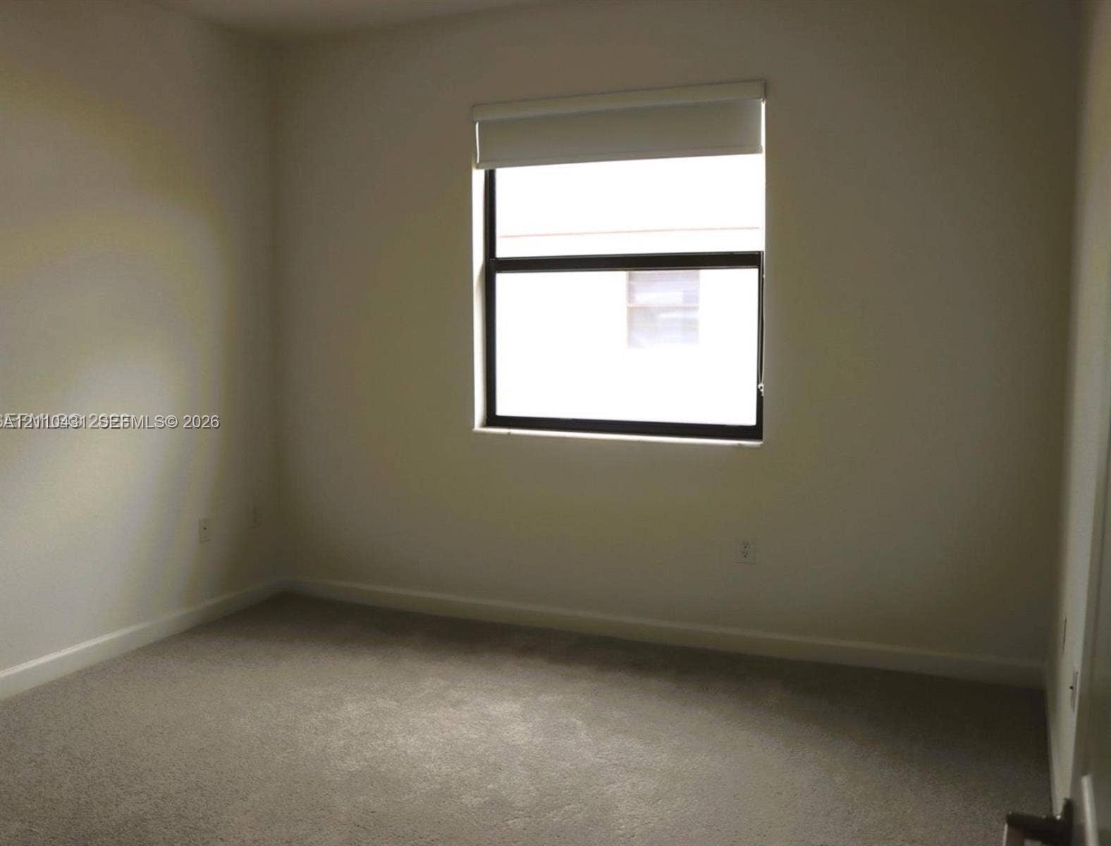 23452 SW 129th Avenue, Homestead, FL 33032 Neutral wall palette, wall-to-wall carpeting, single-pane window with dark framing, and fitted window shade