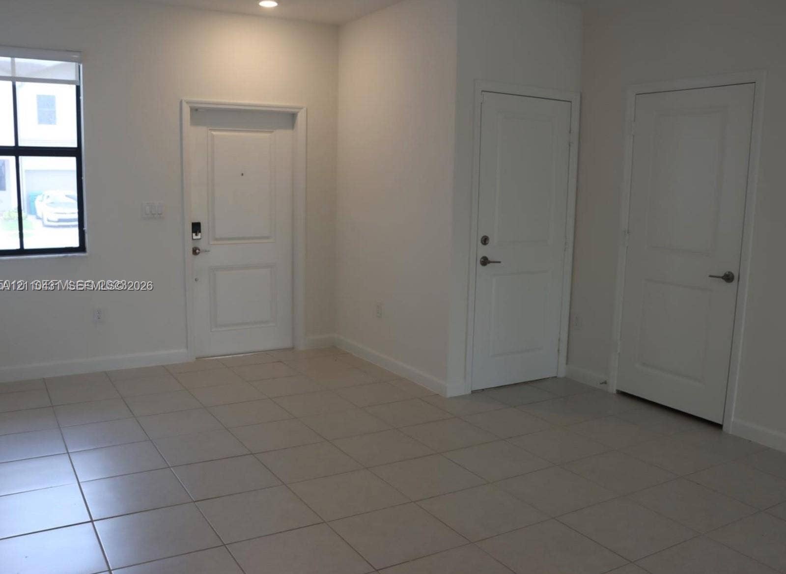 23452 SW 129th Avenue, Homestead, FL 33032 Neutral-toned tile flooring, recessed ceiling lighting, and three panel-style interior doors