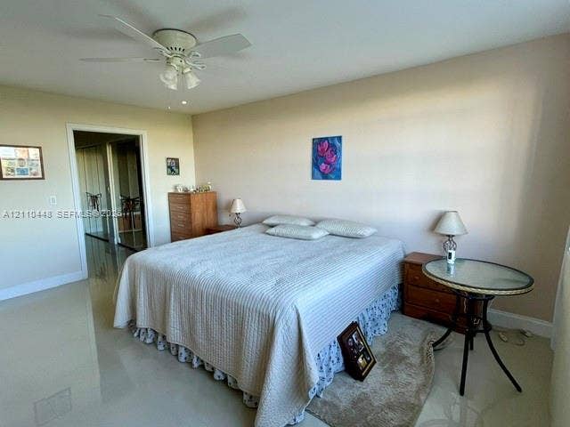2780 NE 183rd Street, #517, Aventura, FL 33160 Neutral-toned interior featuring polished tile flooring, a multi-blade ceiling fan with integrated lighting, and mirrored closet doors