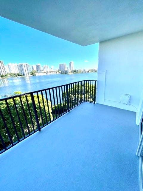 2780 NE 183rd Street, #517, Aventura, FL 33160 Covered balcony featuring concrete flooring, black metal railing, and water frontage