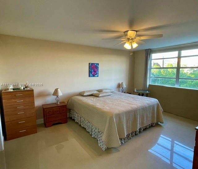 2780 NE 183rd Street, #517, Aventura, FL 33160 Spacious room featuring neutral wall tones, polished tile flooring, a multi-blade ceiling fan with integrated lighting, and expansive windows